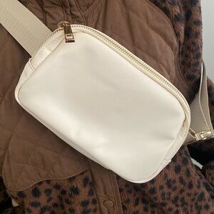 White belt bag with gold accents
